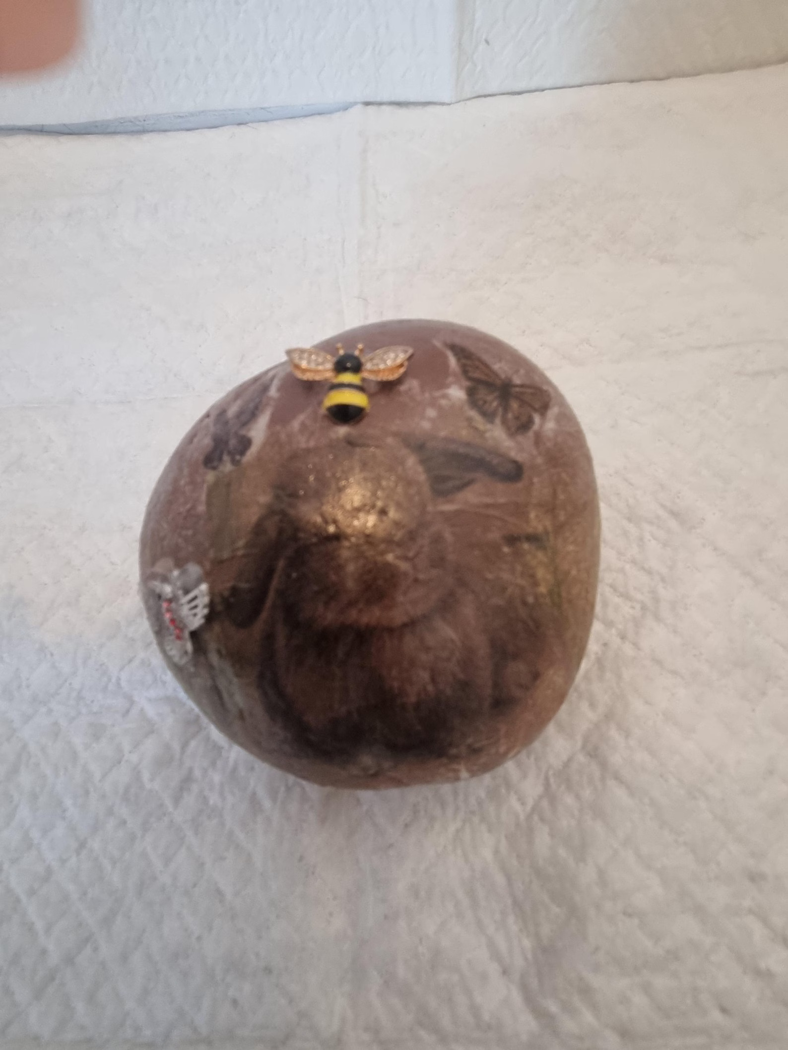 Front view of brown weighted doorstop with bunny and bee image